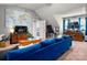 Inviting living room with a plush blue sectional sofa, media center, and large world map decor at 8619 New Oak Ln, Huntersville, NC 28078