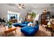Comfortable living room with a plush blue sectional sofa, vaulted ceilings, and a wooden bookshelf at 8619 New Oak Ln, Huntersville, NC 28078