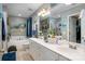 Large main bathroom with double vanity, a soaking tub, and elegant fixtures at 8619 New Oak Ln, Huntersville, NC 28078