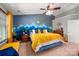 Comfortable main bedroom with a statement wall, fan, and great natural light at 8619 New Oak Ln, Huntersville, NC 28078