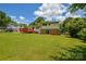 Backyard featuring a spacious lawn, brick foundation, and a wooden deck at 923 Yuma St, Charlotte, NC 28213