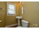 Bathroom with pedestal sink, toilet and window for natural light at 923 Yuma St, Charlotte, NC 28213