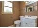 Bathroom featuring a pedestal sink, toilet, and window for natural light at 923 Yuma St, Charlotte, NC 28213