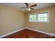 A bedroom with hardwood floors, a window for natural light, and a ceiling fan at 923 Yuma St, Charlotte, NC 28213