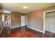 Bedroom includes worn hardwood floors, neutral paint, and a closet at 923 Yuma St, Charlotte, NC 28213