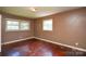 Bedroom features hardwood floors, neutral paint, and natural light from double hung windows at 923 Yuma St, Charlotte, NC 28213
