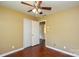 The bedroom has hardwood floors, neutral paint, a closet, and a ceiling fan with a light at 923 Yuma St, Charlotte, NC 28213