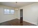 An open-concept dining room with hardwood floors and a modern hanging light fixture at 923 Yuma St, Charlotte, NC 28213