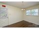 The dining room has hardwood floors, a vintage light fixture, and an exit door at 923 Yuma St, Charlotte, NC 28213