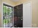 Front door featuring a black decorative security door and an inside view of foyer at 923 Yuma St, Charlotte, NC 28213