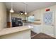 Kitchen featuring white cabinets, tile backsplash, island, and black appliances at 923 Yuma St, Charlotte, NC 28213