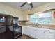 An eat-in kitchen with painted cabinets, stainless steel appliances, and a window over the sink at 923 Yuma St, Charlotte, NC 28213