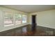 Spacious living room with hardwood floors, large windows, and neutral wall color at 923 Yuma St, Charlotte, NC 28213