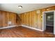 Living room offers wood paneled walls and wood floors with access to the upstairs at 923 Yuma St, Charlotte, NC 28213