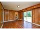 Living room offers wood paneled walls, wood floors and access to outside at 923 Yuma St, Charlotte, NC 28213