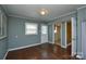 Cozy living room featuring hardwood floors, a window, and a door to a bedroom at 923 Yuma St, Charlotte, NC 28213