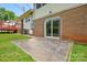 Home's backyard has a concrete patio, with a brick foundation and a sliding glass door at 923 Yuma St, Charlotte, NC 28213