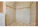 The tiled shower has a decorative accent border and mosaic tile floor at 923 Yuma St, Charlotte, NC 28213