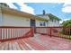 Home's wooden deck shows peeling paint, a satellite, and a green yard in the background at 923 Yuma St, Charlotte, NC 28213