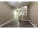 Finished basement with wood flooring, decorative columns, and a staircase leading to the upper level at 1009 Brookline Dr, Huntersville, NC 28078