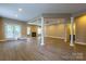 Open basement area with wood floors, a fireplace, recessed lighting, and a doorway leading to the bathroom at 1009 Brookline Dr, Huntersville, NC 28078