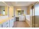 Bright bathroom featuring double vanity sinks and an enclosed glass shower at 1009 Brookline Dr, Huntersville, NC 28078