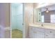 Bathroom with a sink, vanity, mirror, and a door to a walk-in closet with ample storage at 1009 Brookline Dr, Huntersville, NC 28078