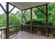Inviting outdoor deck with wooden railing, offering a serene retreat amidst lush greenery and flowering trees at 1009 Brookline Dr, Huntersville, NC 28078