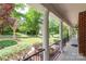 Inviting front porch with classic columns, iron railings, and manicured landscaping at 1009 Brookline Dr, Huntersville, NC 28078