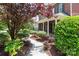 Charming brick home featuring a well-manicured front lawn and mature landscaping at 1009 Brookline Dr, Huntersville, NC 28078