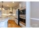 Modern kitchen boasts stainless steel appliances, granite countertops, and custom white cabinetry at 1009 Brookline Dr, Huntersville, NC 28078