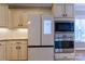 Modern kitchen featuring stainless steel appliances, custom white cabinetry, and hardwood flooring at 1009 Brookline Dr, Huntersville, NC 28078