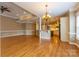 Expansive living room with hardwood floors, natural light and elegant lighting fixture at 1009 Brookline Dr, Huntersville, NC 28078