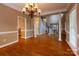 Open-concept living space with hardwood floors, grand pillars, and staircase view at 1009 Brookline Dr, Huntersville, NC 28078