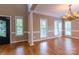 Bright, spacious living room with a chandelier, hardwood floors, and large windows at 1009 Brookline Dr, Huntersville, NC 28078