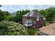 Brick home featuring a sunroom and well-maintained yard with mature trees at 1009 Brookline Dr, Huntersville, NC 28078