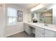 This bathroom features a double vanity, modern lighting, large mirror, and a glass enclosed shower at 10112 Andres Duany Dr, Huntersville, NC 28078