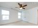 Bright bedroom features neutral carpet, windows, a ceiling fan, and a closet for ample storage at 10112 Andres Duany Dr, Huntersville, NC 28078