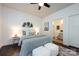 Stylish bedroom with accent wall decor, a ceiling fan, and an ensuite bathroom at 10112 Andres Duany Dr, Huntersville, NC 28078