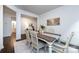 Dining room with a wooden table, white chairs, a white rug, and an art piece on the wall at 10112 Andres Duany Dr, Huntersville, NC 28078