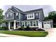 Two-story home with blue siding, white trim, attached two car garage, and a manicured front yard at 10112 Andres Duany Dr, Huntersville, NC 28078