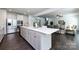 Bright kitchen with large island, stainless steel appliances, and open floor plan to the living room at 10112 Andres Duany Dr, Huntersville, NC 28078