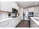 Kitchen features white cabinets, stainless steel appliances, hardwood floors, and white subway tile backsplash at 10112 Andres Duany Dr, Huntersville, NC 28078