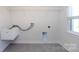 Functional laundry room with a utility sink, connections for washer and dryer, and shelving at 10112 Andres Duany Dr, Huntersville, NC 28078