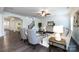 Living room featuring hardwood floors, white walls, gray chairs, area rug, ceiling fan, and a staircase at 10112 Andres Duany Dr, Huntersville, NC 28078