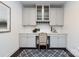 Home office with gray cabinets, light countertops, a chair, an area rug, and white subway tile backsplash at 10112 Andres Duany Dr, Huntersville, NC 28078