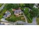 An aerial view showcases a meticulously landscaped brick home with mature trees and a well-manicured lawn at 103 Samuel Guilford Ct, Charlotte, NC 28270
