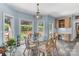 Charming breakfast nook featuring a glass table, bright windows, and built-in cabinetry at 103 Samuel Guilford Ct, Charlotte, NC 28270