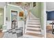 Grand foyer with a staircase, elegant tile flooring, and views into the adjoining rooms at 103 Samuel Guilford Ct, Charlotte, NC 28270