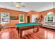 Spacious game room with pool table, wood floors, and large windows provides endless entertainment opportunities at 103 Samuel Guilford Ct, Charlotte, NC 28270